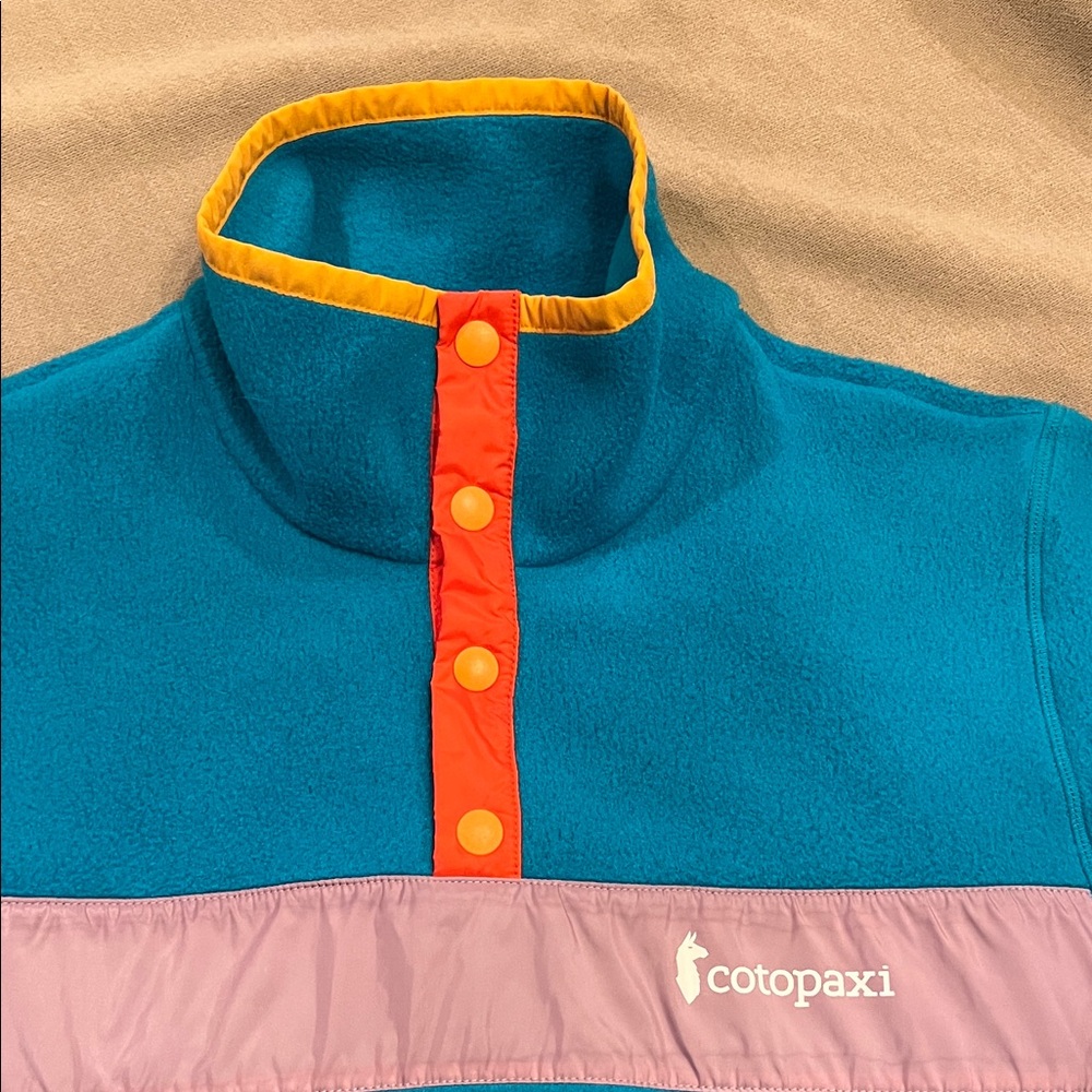 cotopaxi Teal Fleece Pullover with Pink Panel and Orange Snap Placket